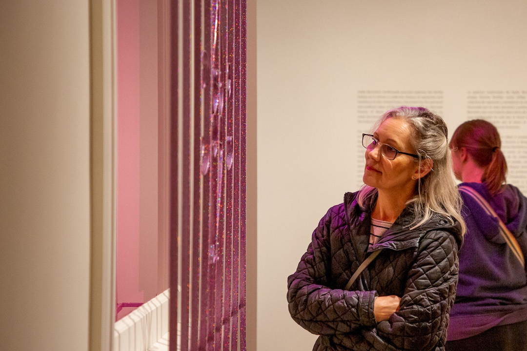 Visitor looking at glittery bar window
