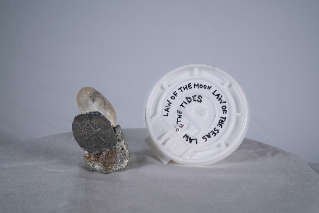 rock and a plastic cup lid