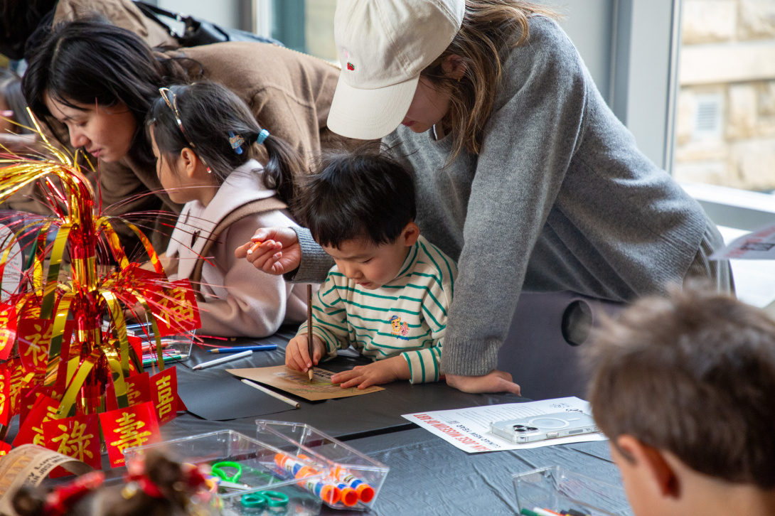 child and parent working on an art activity together