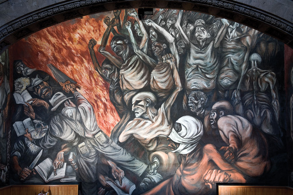 A mural of skeleton-like figures with their hands up in distress. One has bandages around his head. There is fire behind them. To the left there are men holding books and weapons such as a knife and a saw. 