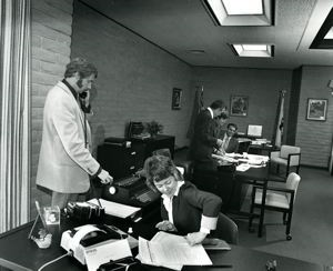 Image of Untitled (office scene, woman and staple action) from the "Working (I Do It For The Money)" series