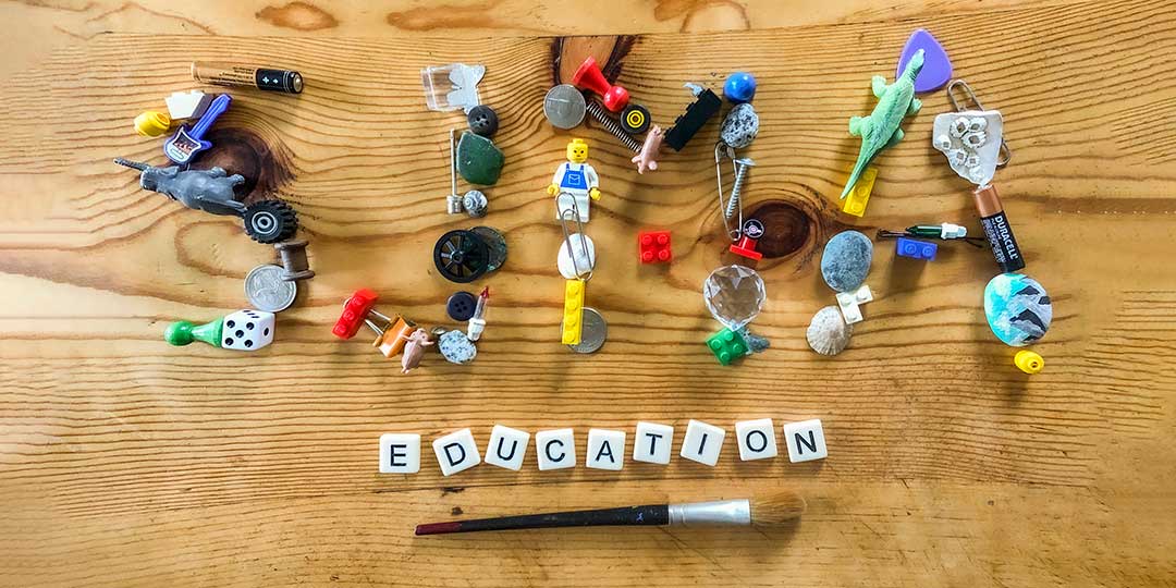 Small toys and objects arranged to spell the word SJMA.