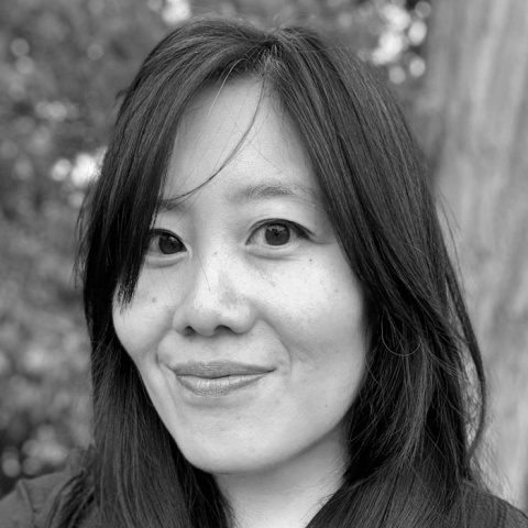 Black-and-white headshot of a woman outdoors.