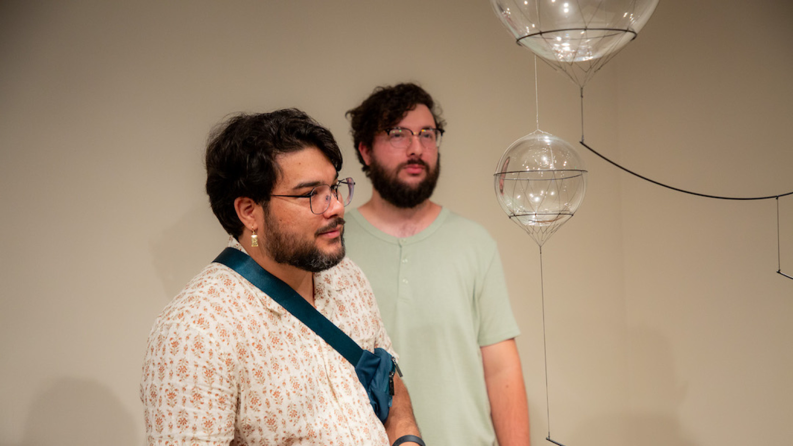 visitors gazing intently at a glass orb