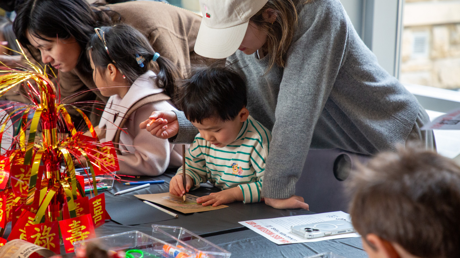 child and parent working on an art activity together
