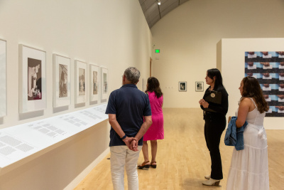 latina woman giving a museum tour in a photographic exhibition