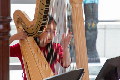 teenage girl playing the harp