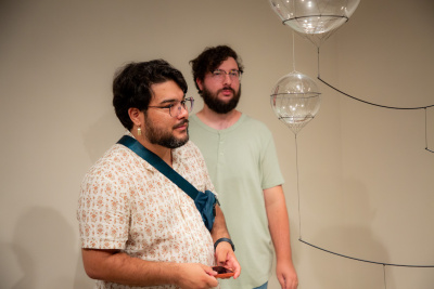 visitors gazing intently at a glass orb