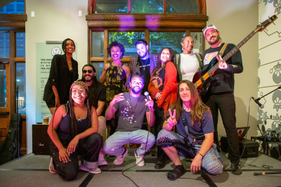 a group photo of ten diverse artists, musicians, poets, and dancers 