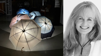 Umbrellas with constellation renderings and white woman with shoulder length hair