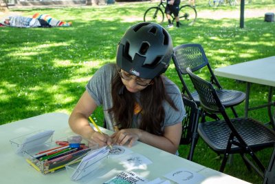 girl wearing helmet drawing and coloring