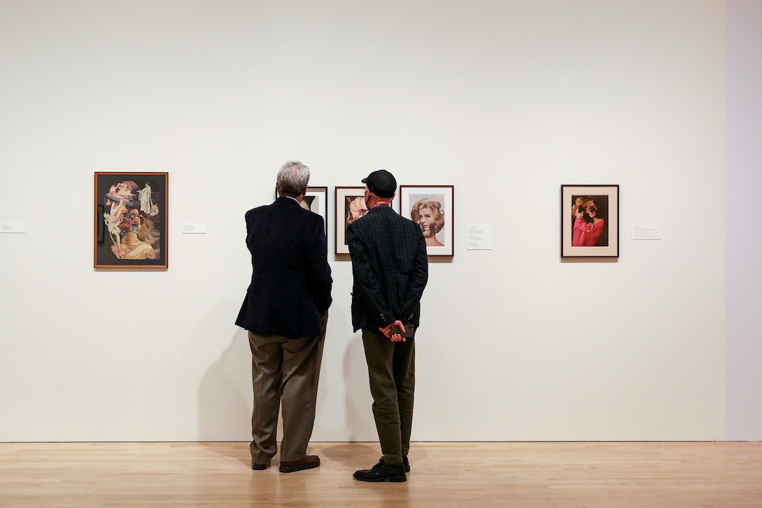 Visitors looking at a collage.