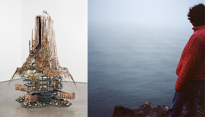 An abstract sculpture and a man overlooking the ocean.