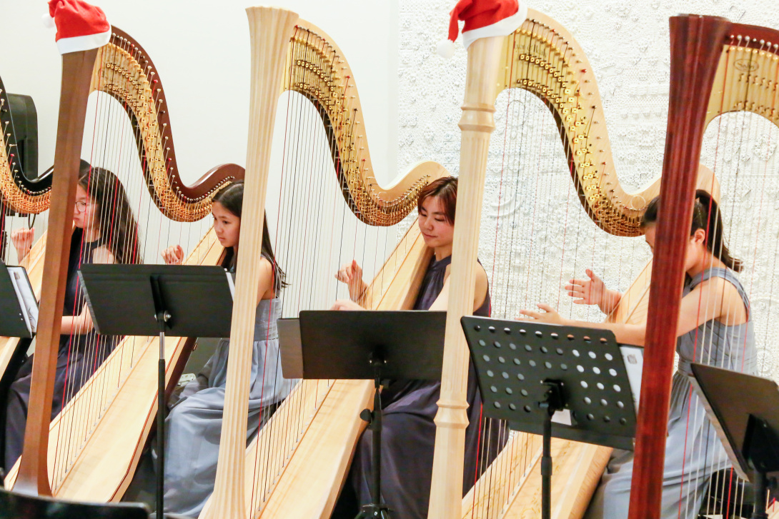 Youth musicians playing harps.