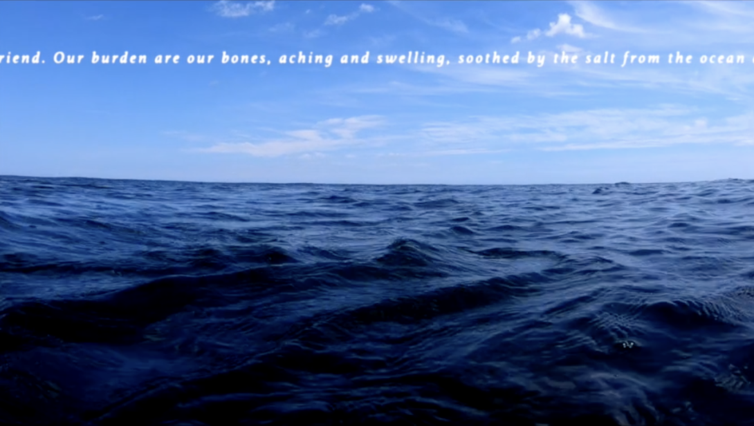 Open ocean with a poem in white subtitles on the top.