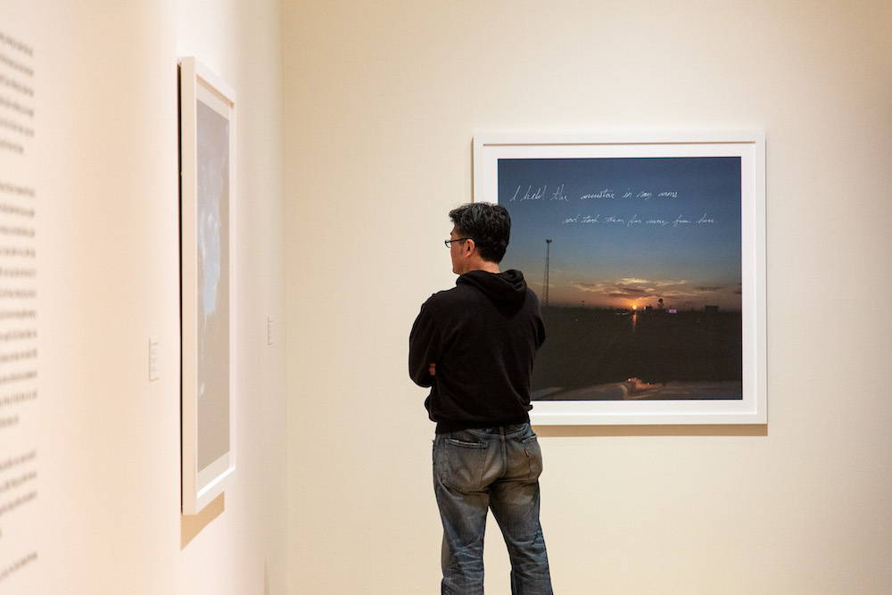 Curious visitor looking at a photograph.