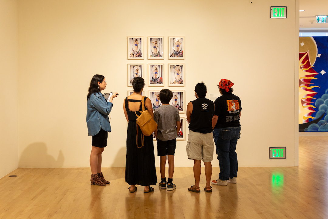 tour group looking at multiple photographs