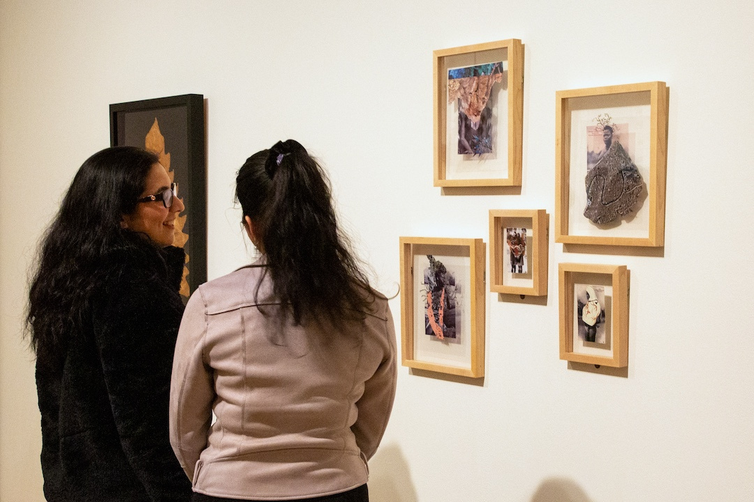 two women looking at collages