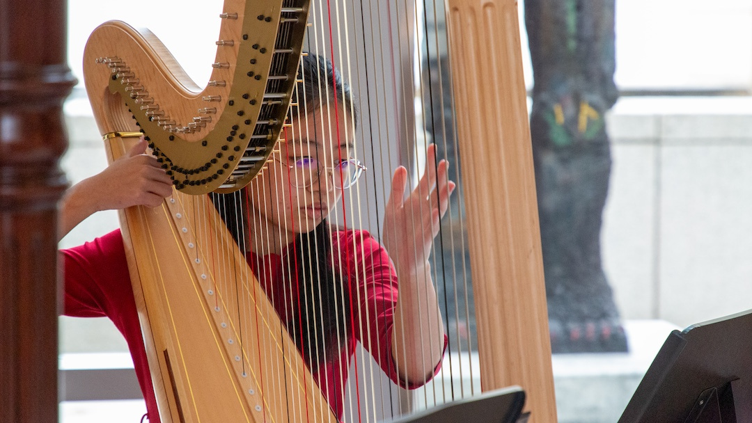 teenage girl playing the harp