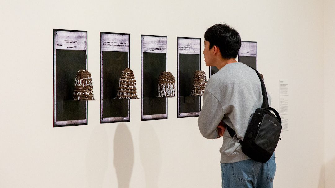 visitor looking intently at an artwork