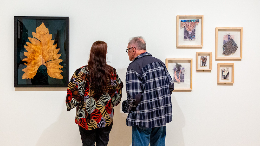 two visitors looking at an artwork
