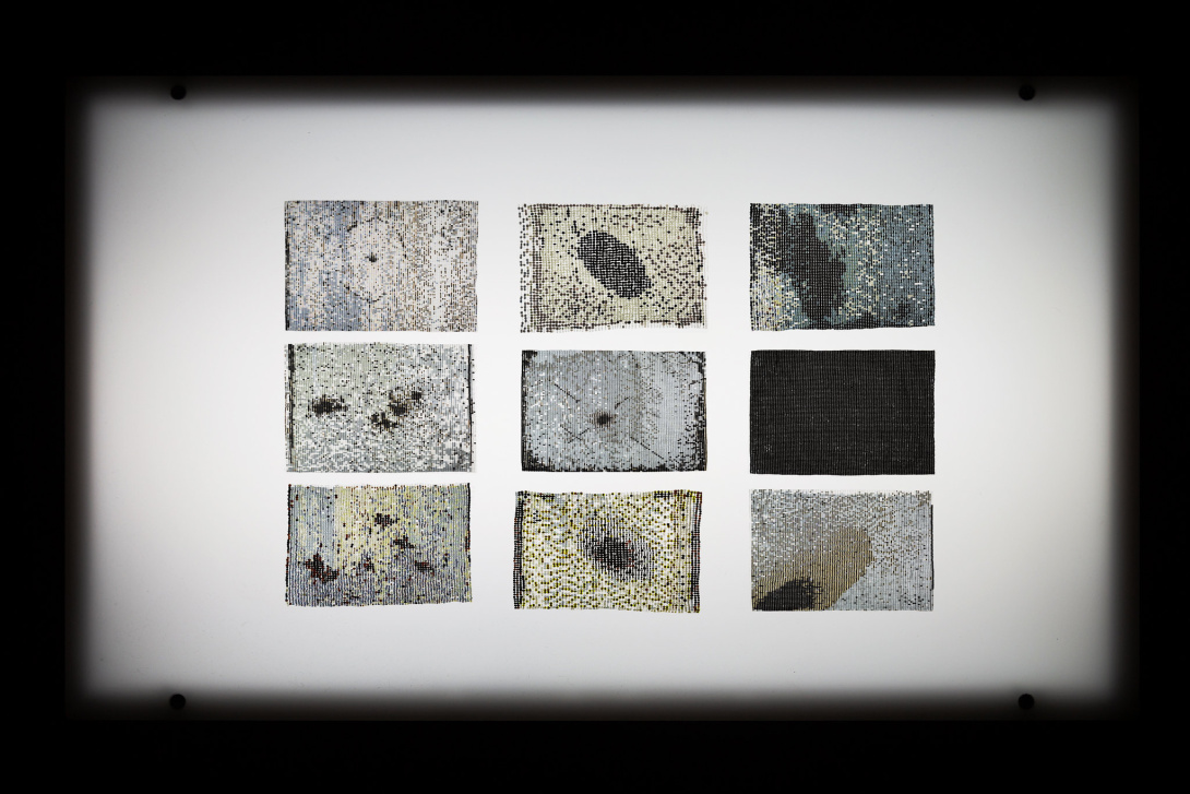 nine rectangular beaded textile pieces depicting abstract compositions laid out in a three by three grid