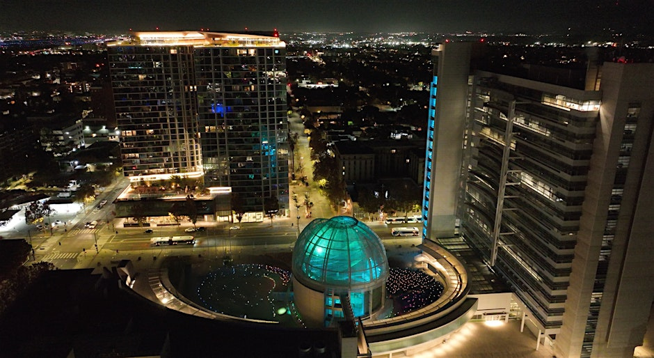 aerial view of an urban landscape at night with multiple people illuminating