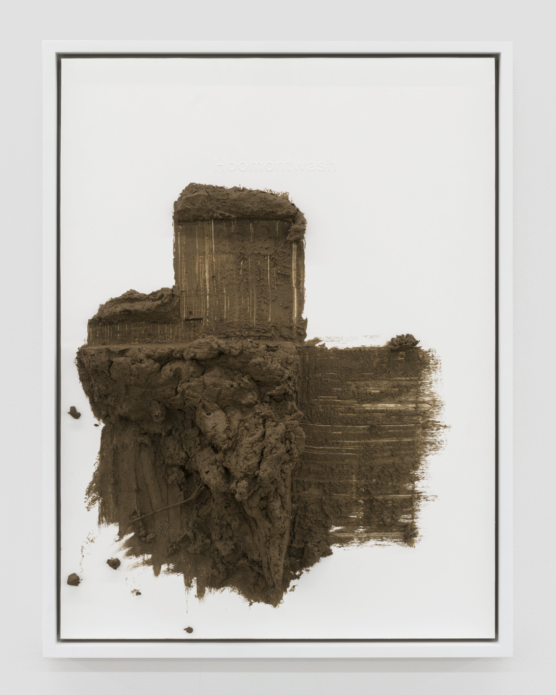 adobe mud scrapped on a panel with embossed text