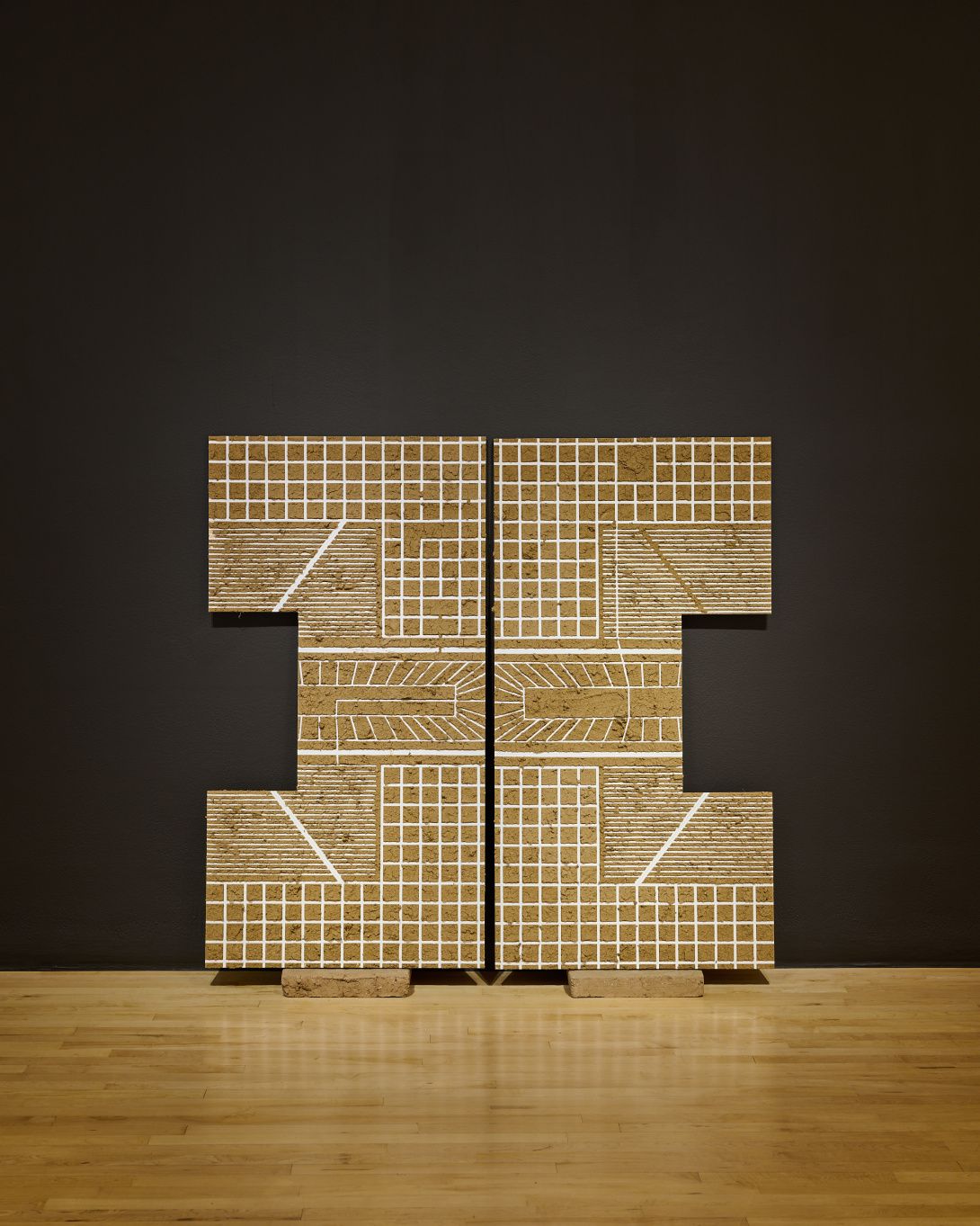 Two gridded panels arranged side by side, forming a paired, geometric composition with a structured, map-like layout.