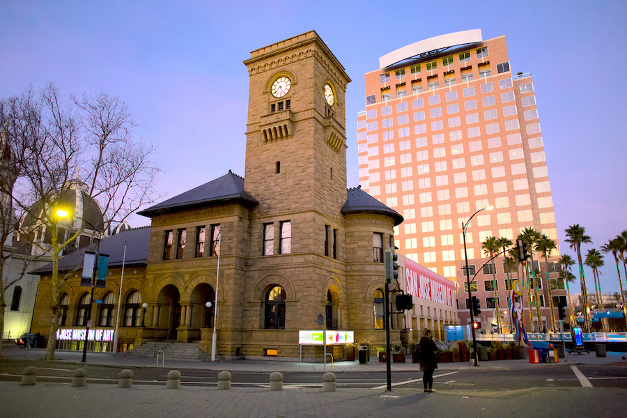 Museum building at dusk with ice rink to the right.