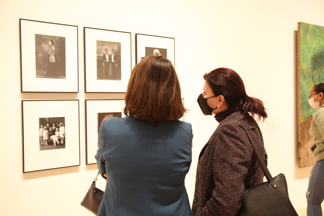 Two women looking at photographs.