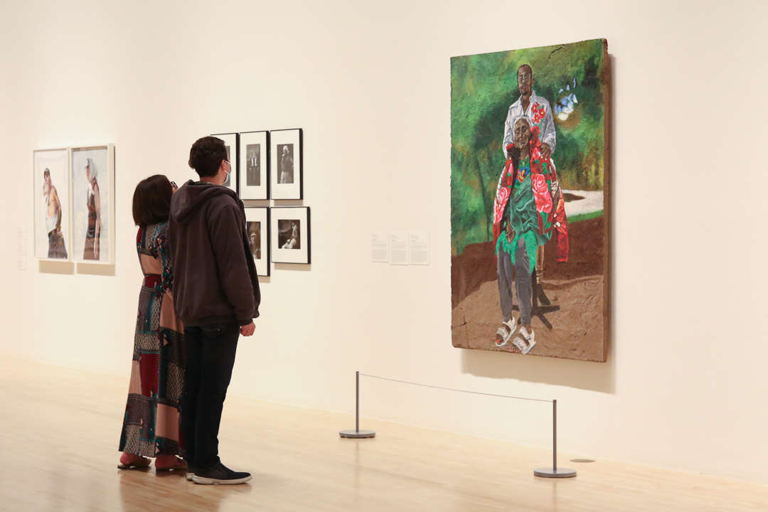 Two visitors looking at an artwork.