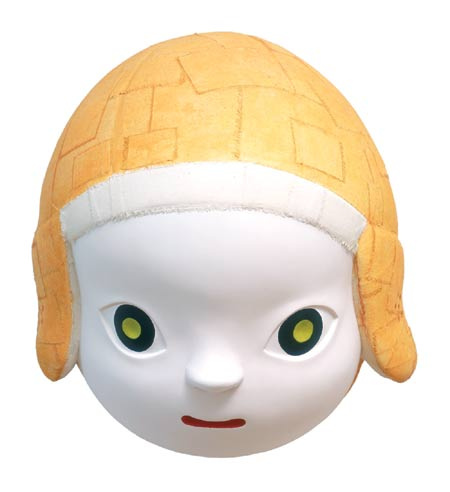 A white ceramic child's head with big round green eyes. They are wearing a helmet that looks like a cloth vintage football player's helmet.