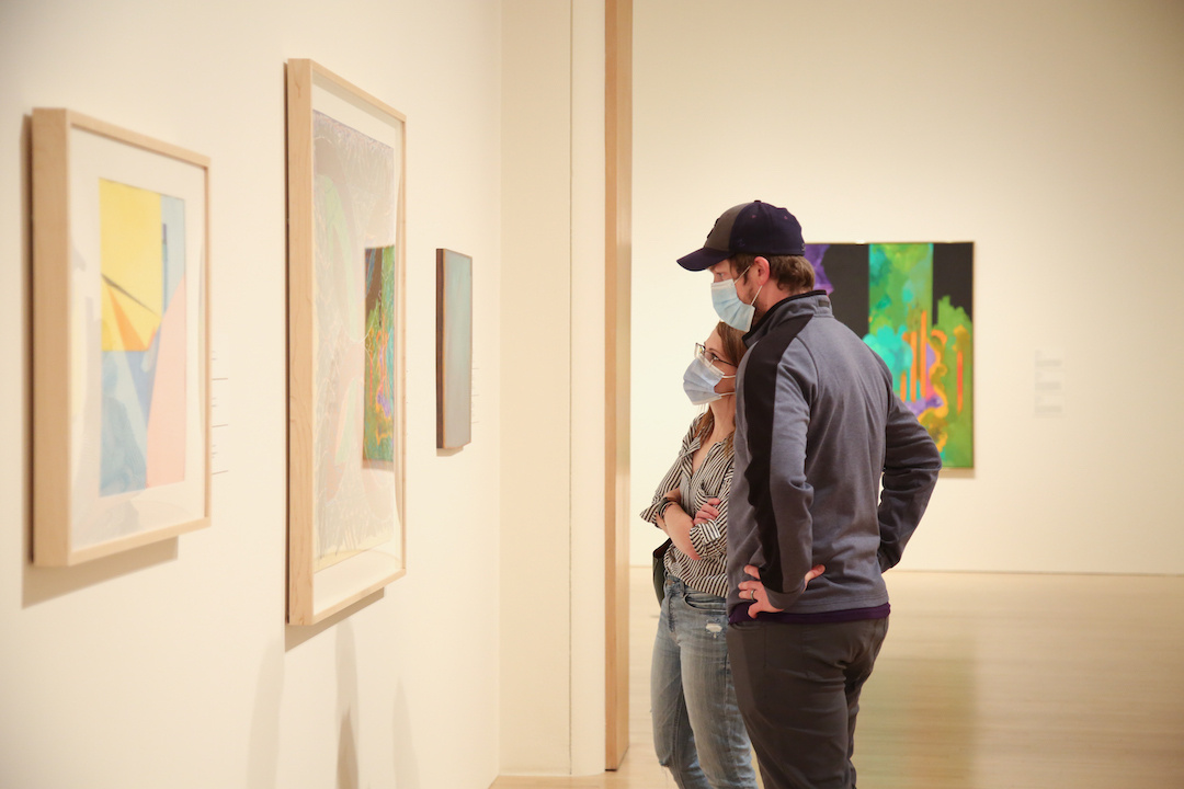 Two people looking at an artwork.