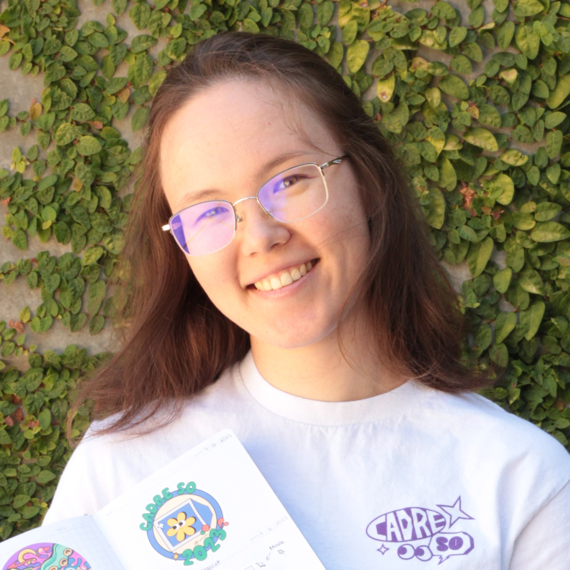 a young woman with short reddish brown hair and glasses
