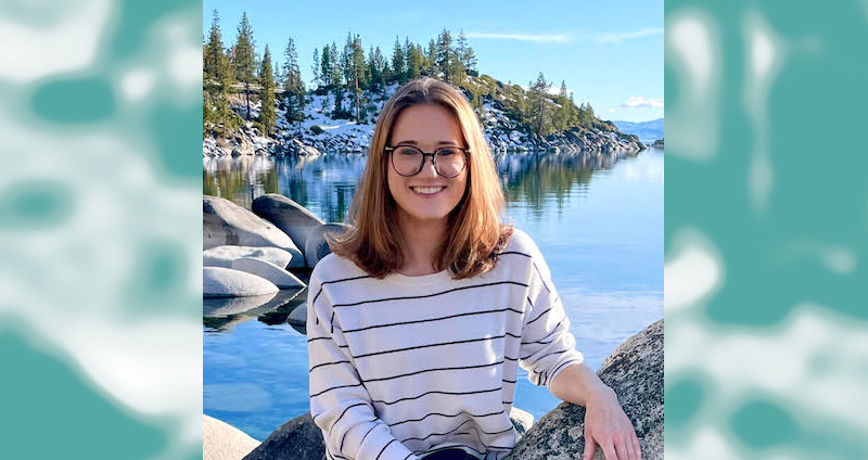 headshot of woman with glasses with a snowy landscape background