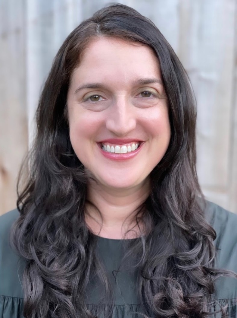 a woman with wavy dark brown hair