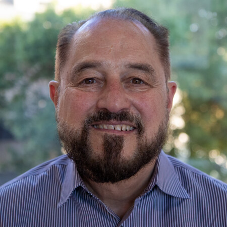 man with beard wearing a striped shirt